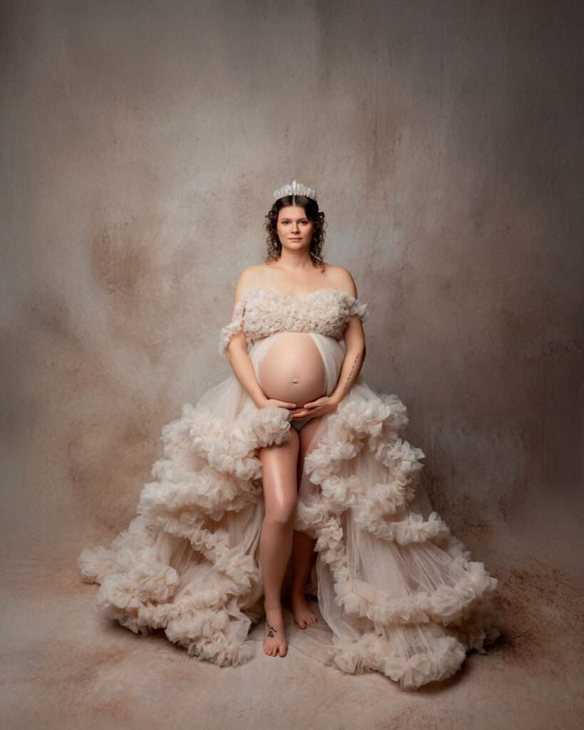 Pregnant mother posing softly during a studio maternity photography session with Kaitlyn Dawn Photography