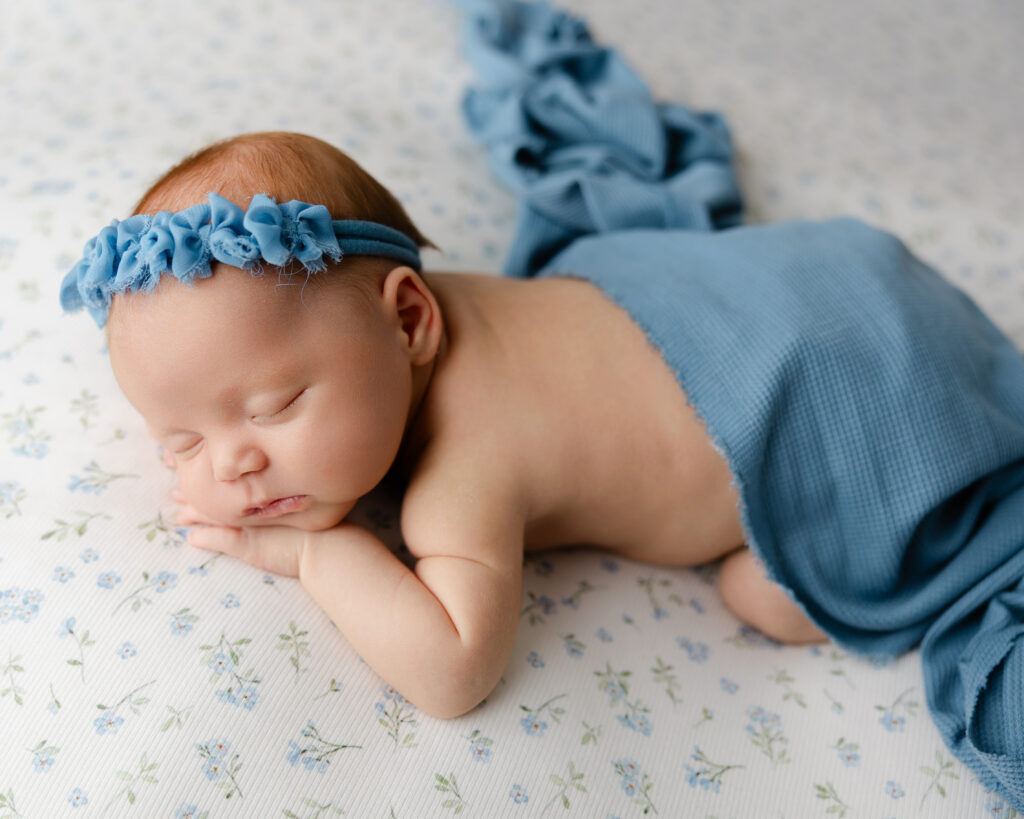 Newborn photography in Redlands featuring studio portraits of sleeping babies styled in soft blue and neutral tones