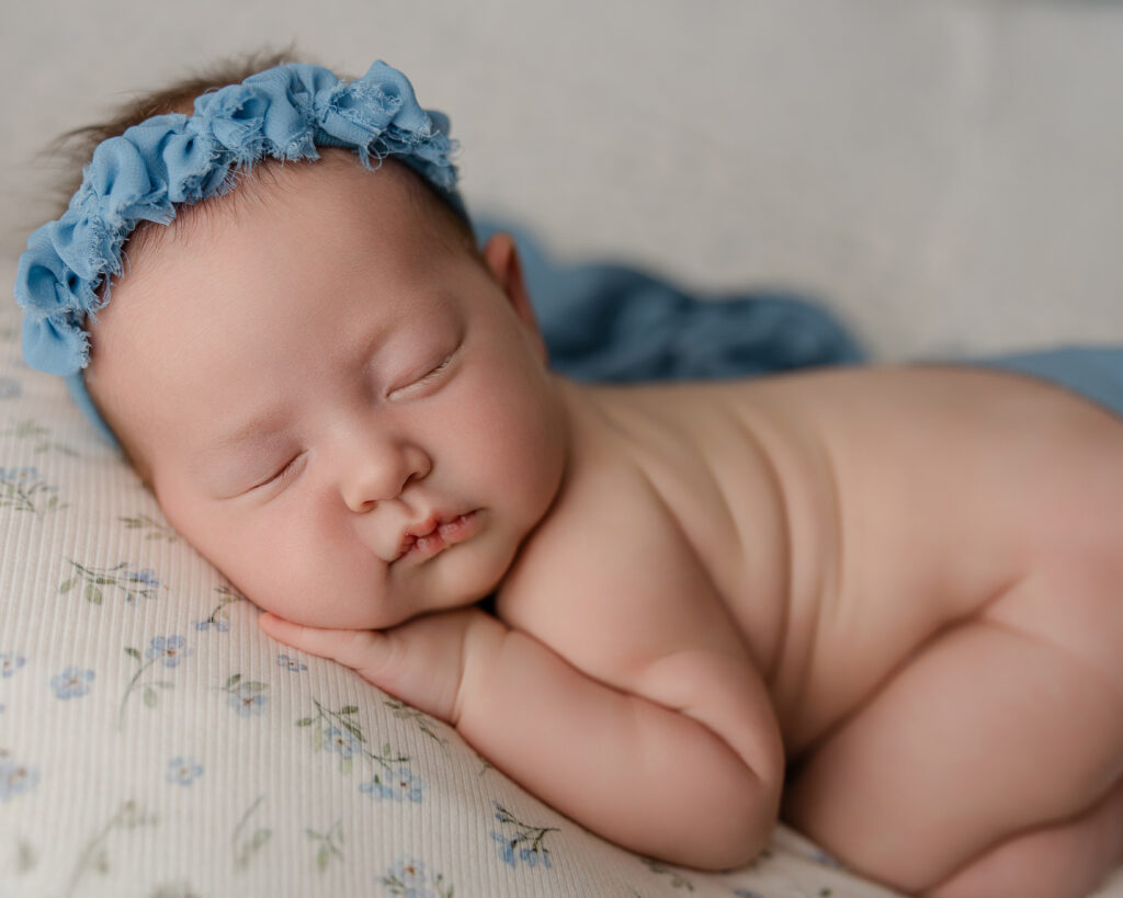 Peaceful newborn resting during breastfeeding support in early motherhood, highlighting comfort and gentle care.