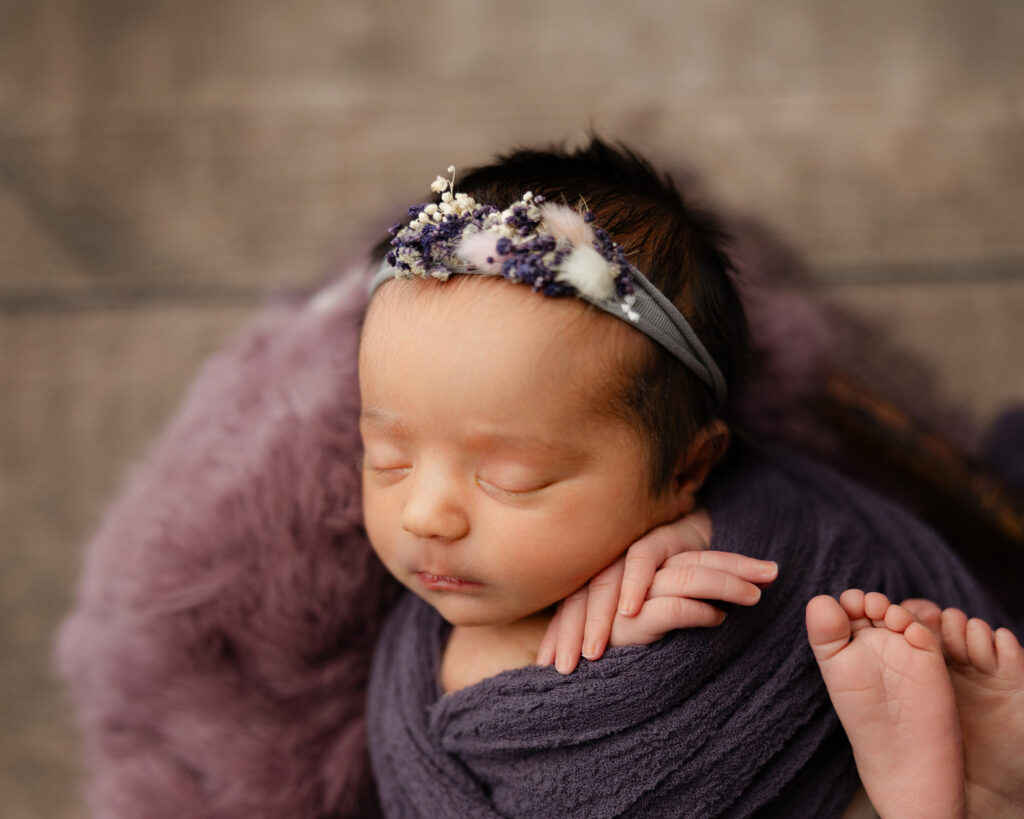 Safe newborn sleep photographed in Redlands with baby swaddled comfortably and resting on a soft textured backdrop