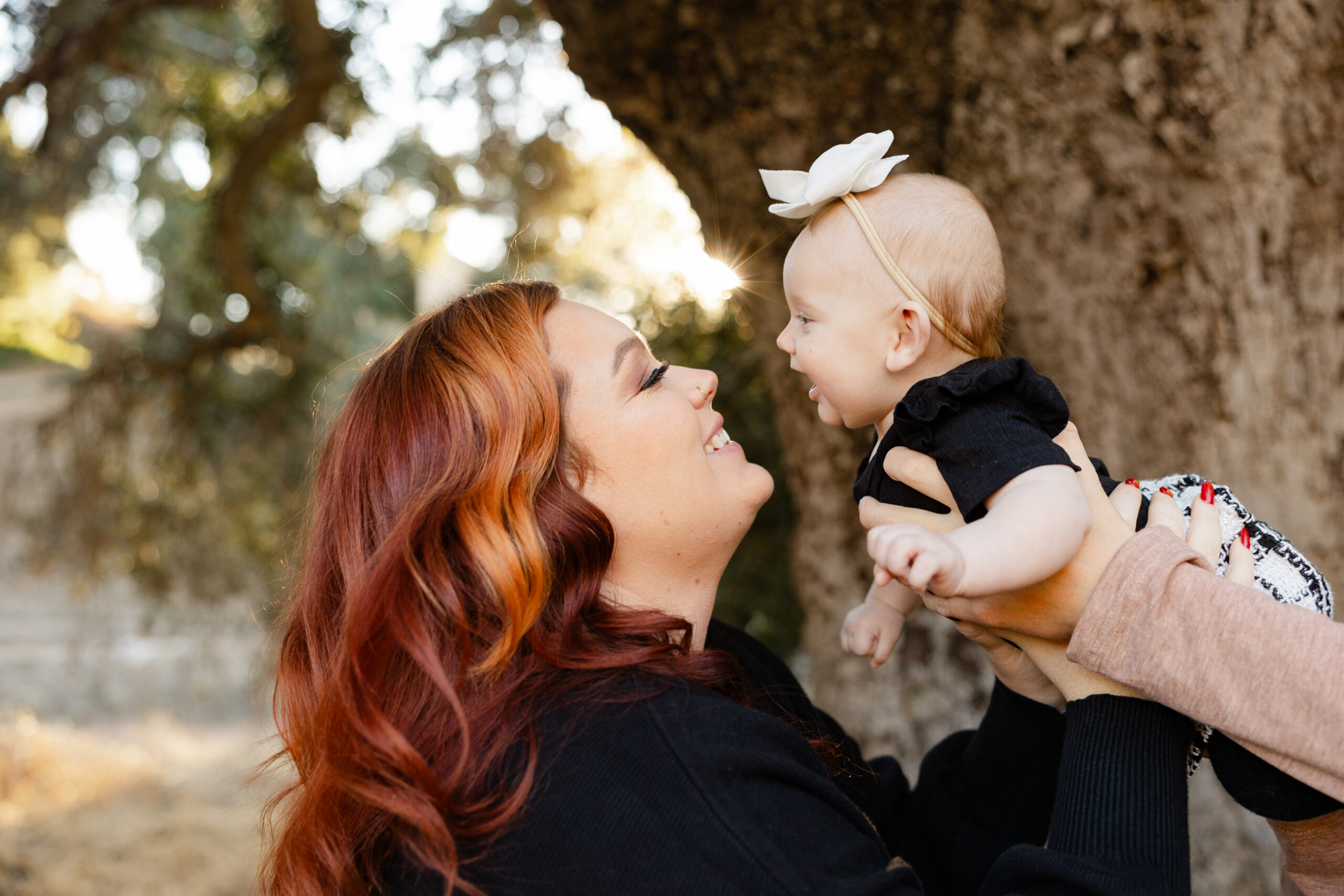 Mother smiling at her baby during an outdoor family session inspired by the Best Places to Take a Toddler in the Inland Empire. Photograph by Kaitlyn Dawn Photography.