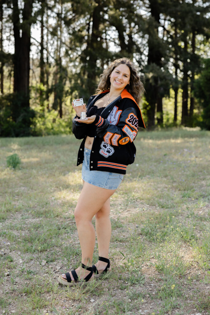 Senior girl wearing a jacket during senior session by Kaitlyn Dawn Photography.