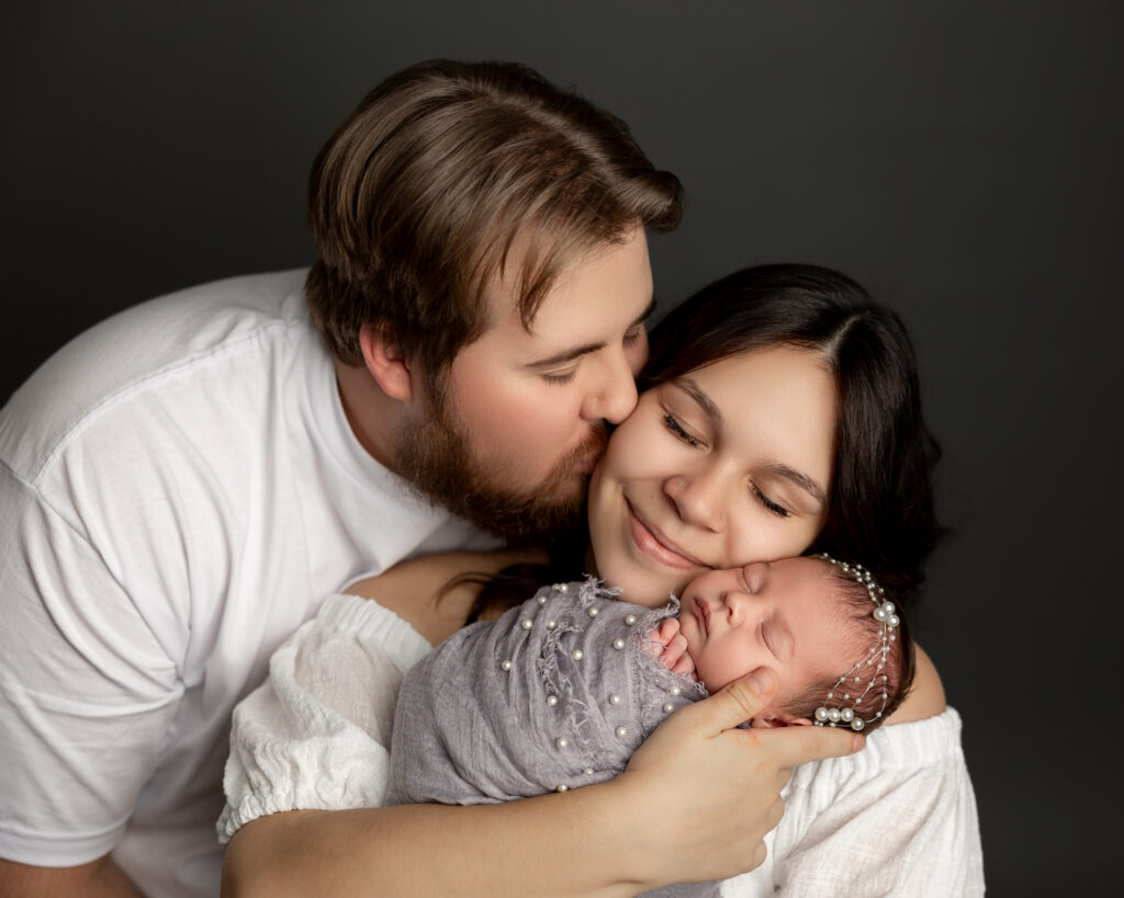 Yucaipa newborn photography session capturing the emotional connection between new parents and their baby.