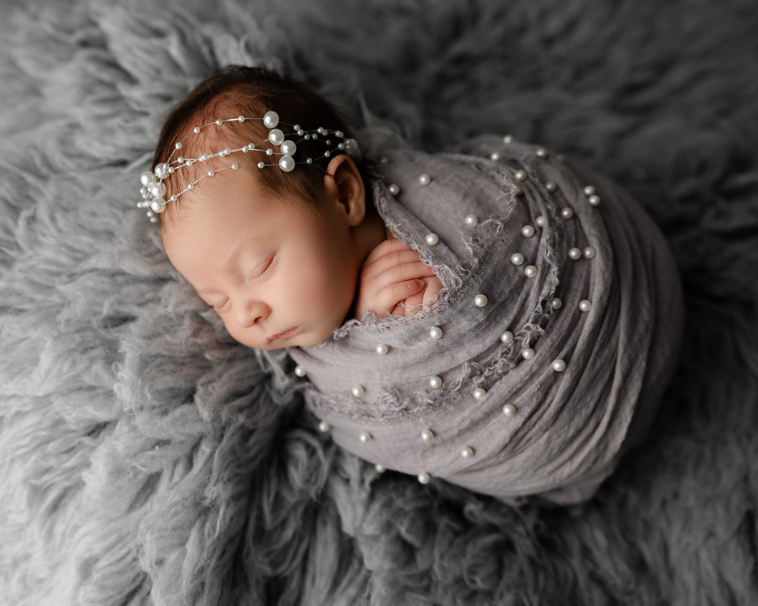 Sleepy newborn photographed by Yucaipa newborn photographer during the first difficult weeks with a baby.