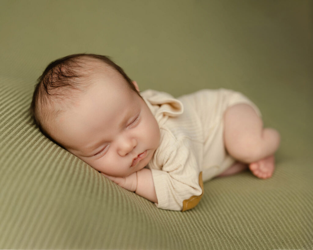 Overhead view of a sleeping infant during a 6 week newborn milestone session by Kaitlyn Dawn Photography, preserving the fleeting details parents never want to forget.