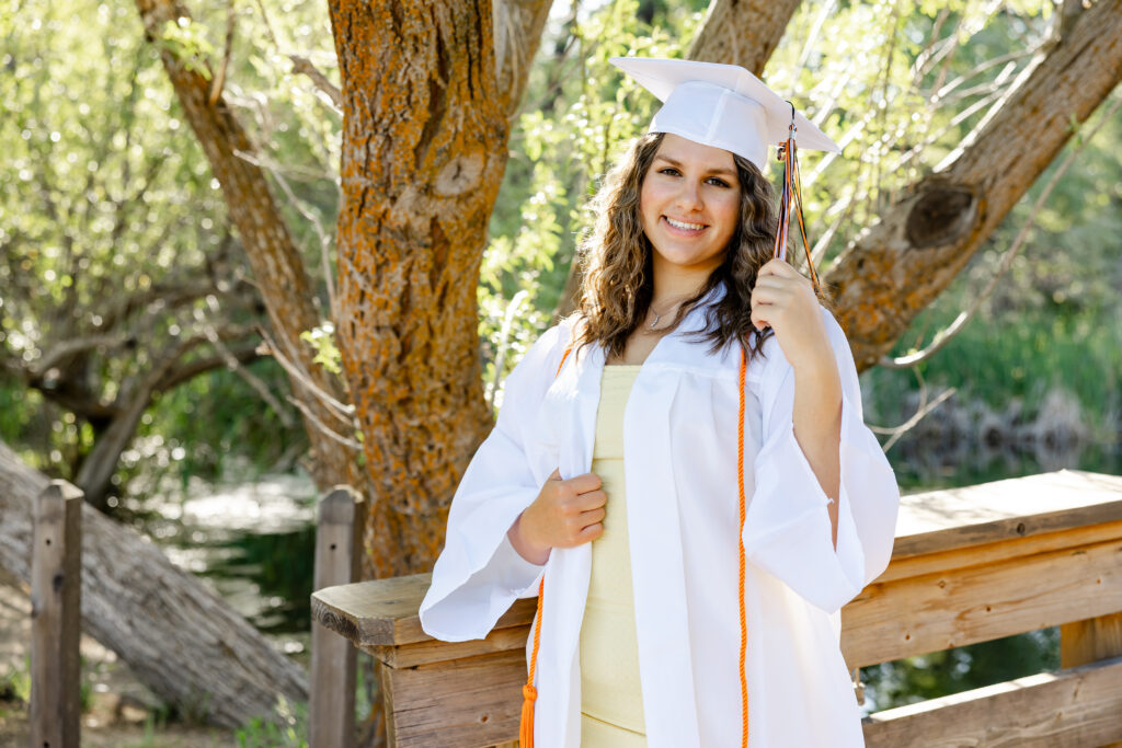 Yucaipa High School graduation portrait featuring a senior in her white cap and gown during a photo session in Yucaipa.