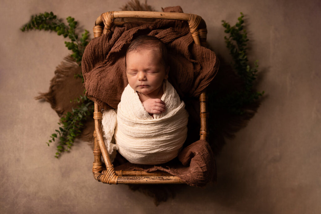 Baby swaddled in a basket 